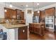 Spacious kitchen featuring granite counters, stainless steel appliances, and dark wood cabinets at 3169 Shadystone Way, Loganville, GA 30052
