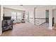 Upstairs loft featuring cozy seating and a staircase with elegant wrought iron railings at 3169 Shadystone Way, Loganville, GA 30052