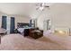 Spacious main bedroom featuring a cozy armchair, ample natural light, and an ensuite bathroom at 3169 Shadystone Way, Loganville, GA 30052