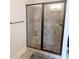 Modern shower with a glass enclosure, stone tiles, and a built-in bench offers a spa-like experience at 3169 Shadystone Way, Loganville, GA 30052