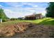 A spacious backyard featuring a well-maintained lawn, multi-tiered deck, and storage shed, perfect for outdoor enjoyment at 3925 Orchard Se Rd, Smyrna, GA 30080