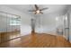 Bedroom with hardwood floors, ceiling fan, and a closet with mirrored doors at 3925 Orchard Se Rd, Smyrna, GA 30080
