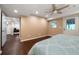 Bright bedroom features hardwood floors, a ceiling fan, and an exterior access door at 3925 Orchard Se Rd, Smyrna, GA 30080