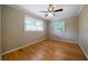 This bedroom has hardwood floors, neutral paint and a ceiling fan at 3925 Orchard Se Rd, Smyrna, GA 30080