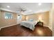 Bright bedroom features hardwood floors, a ceiling fan, and an exterior access door at 3925 Orchard Se Rd, Smyrna, GA 30080