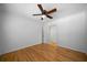 This bedroom has hardwood floors, neutral paint and a ceiling fan at 3925 Orchard Se Rd, Smyrna, GA 30080