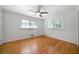 Sunlit bedroom featuring hardwood floors, a ceiling fan and multiple windows at 3925 Orchard Se Rd, Smyrna, GA 30080
