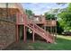 Multi-level deck features wooden railings and stairs to the yard at 3925 Orchard Se Rd, Smyrna, GA 30080