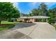 Charming brick home with a covered parking area and a spacious, paved driveway at 3925 Orchard Se Rd, Smyrna, GA 30080