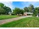 Lush lawn and mature trees complement the exterior of this well-maintained home at 3925 Orchard Se Rd, Smyrna, GA 30080