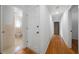 Hallway with hardwood floors and doorways to bathroom and other rooms at 3925 Orchard Se Rd, Smyrna, GA 30080