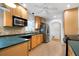 Well-lit kitchen features wood cabinets, stainless steel appliances, and hardwood floors at 3925 Orchard Se Rd, Smyrna, GA 30080