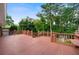 Wooden outdoor deck featuring decorative railing and a view of the wooded property at 3925 Orchard Se Rd, Smyrna, GA 30080