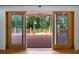 View of outdoor deck through sliding doors with natural sunlight shining in at 3925 Orchard Se Rd, Smyrna, GA 30080