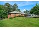 Well-manicured lawn and mature trees surround this beautiful brick home at 3925 Orchard Se Rd, Smyrna, GA 30080