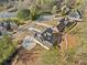 Stunning aerial view of modern home with lake, cul-de-sac street, and lush green landscaping at 52 Lake Overlook Dr, White, GA 30184