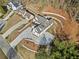 Aerial view of home highlighting the landscaping, large driveway, and surrounding wooded areas at 52 Lake Overlook Dr, White, GA 30184