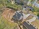 Aerial view of the home showcasing its modern architecture, long driveway, and waterfront location at 52 Lake Overlook Dr, White, GA 30184