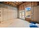 Unfinished basement with framed walls, and walkout access to the backyard at 52 Lake Overlook Dr, White, GA 30184