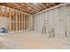 Spacious unfinished basement featuring concrete floors and walls, wood beams, and a ladder at 52 Lake Overlook Dr, White, GA 30184