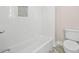 Bathroom featuring a bathtub with tile surround and a toilet at 52 Lake Overlook Dr, White, GA 30184