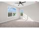 Bedroom with gray carpet, white walls, and a bright window overlooking trees at 52 Lake Overlook Dr, White, GA 30184