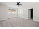 Carpeted bedroom featuring neutral walls, a ceiling fan, double closets and a window at 52 Lake Overlook Dr, White, GA 30184