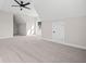 Bright, carpeted bonus room featuring neutral walls, a ceiling fan and attic access at 52 Lake Overlook Dr, White, GA 30184