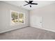 Bedroom featuring gray carpet, light walls, ceiling fan, and window with trees at 52 Lake Overlook Dr, White, GA 30184