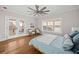 Bright bedroom features hardwood floors, french doors, a ceiling fan, and two comfortable chairs at 52 Lake Overlook Dr, White, GA 30184