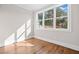 An empty bedroom has a large window and hardwood floors at 52 Lake Overlook Dr, White, GA 30184