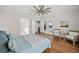 This bedroom has hardwood floors, white trim, ceiling fan and two chairs at 52 Lake Overlook Dr, White, GA 30184