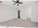 Bedroom with gray carpet, light walls, ceiling fan, and open closet at 52 Lake Overlook Dr, White, GA 30184