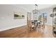 Inviting dining room featuring a modern chandelier, hardwood floors, and backyard view at 52 Lake Overlook Dr, White, GA 30184