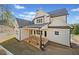 Back of the home with a covered porch and well-manicured lawn at 52 Lake Overlook Dr, White, GA 30184