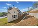 Modern farmhouse exterior showcasing white siding and well-manicured landscaping at 52 Lake Overlook Dr, White, GA 30184