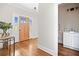 Bright foyer with hardwood floors, wooden front door, and view of the powder room at 52 Lake Overlook Dr, White, GA 30184