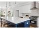Bright kitchen boasts stainless appliances, an island with seating, and pendant lighting at 52 Lake Overlook Dr, White, GA 30184