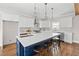 Modern kitchen with island, quartz countertops, stainless steel appliances and bar stool seating at 52 Lake Overlook Dr, White, GA 30184