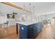 Open concept kitchen boasts a blue island with seating, adjacent to a living space at 52 Lake Overlook Dr, White, GA 30184