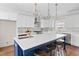 New kitchen featuring white cabinets, blue island with quartz countertop, and pendant lighting at 52 Lake Overlook Dr, White, GA 30184