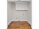 The laundry room has hardwood floors, white trim, and cabinetry above at 52 Lake Overlook Dr, White, GA 30184