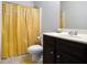 Neutral bathroom featuring tile floors, shower with curtain, and dark wood vanity at 6540 Muirfield Pt, Fairburn, GA 30213