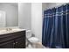 Bathroom featuring vanity with sleek faucet and a tiled shower with blue curtain at 6540 Muirfield Pt, Fairburn, GA 30213