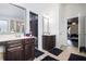 Bright bathroom featuring double vanity sinks and a decorative beaded-curtain closet at 6540 Muirfield Pt, Fairburn, GA 30213