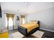 Inviting bedroom with plush bedding, dark wood floors and natural light at 6540 Muirfield Pt, Fairburn, GA 30213