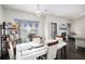 Dining area features a modern table, stylish decor, and large windows for ample natural light at 6540 Muirfield Pt, Fairburn, GA 30213