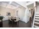 This dining room features dark wood floors, decorative wainscoting, a coffered ceiling and stairs to the second floor at 6540 Muirfield Pt, Fairburn, GA 30213