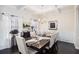 The dining room features hardwood floors, large windows, and elegant decor for comfortable Gathering dining at 6540 Muirfield Pt, Fairburn, GA 30213