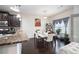 Bright dining area featuring a modern table, dark wood floors, and elegant decor at 6540 Muirfield Pt, Fairburn, GA 30213